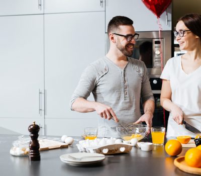 Young husband and wife preparing food for Valentine day