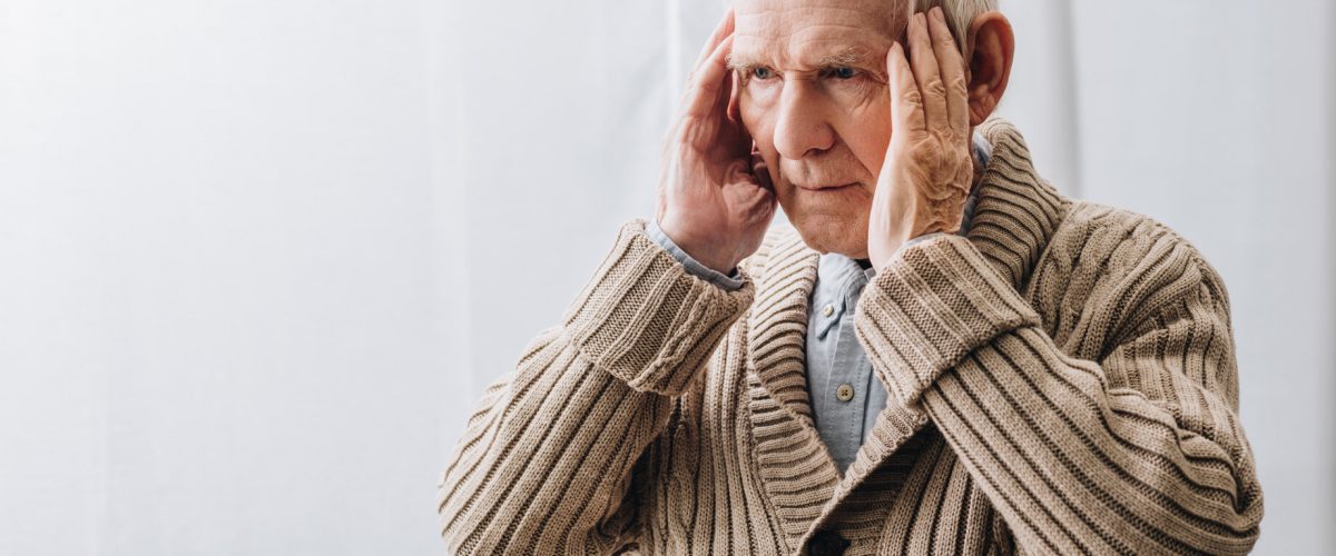 pensioner with dementia disease having headache at home
