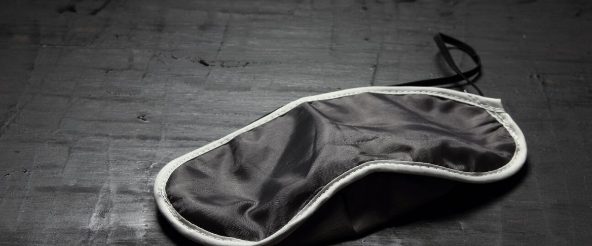 Sleeping Mask on Wooden Background